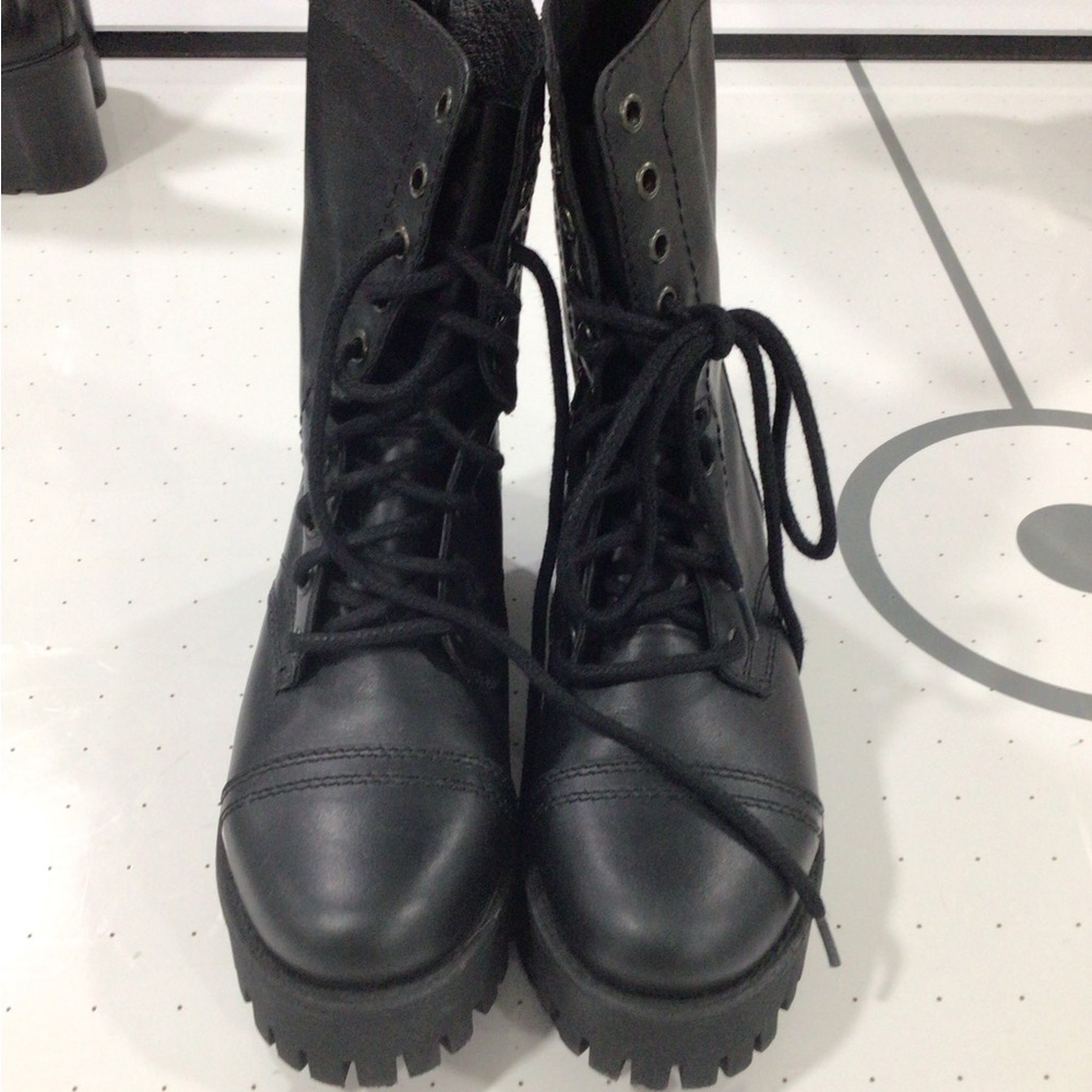 Black leather ankle boots with long black laces and zipper in the back